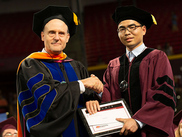 Houqiang Fu receives a plaque from Stephen Phillips