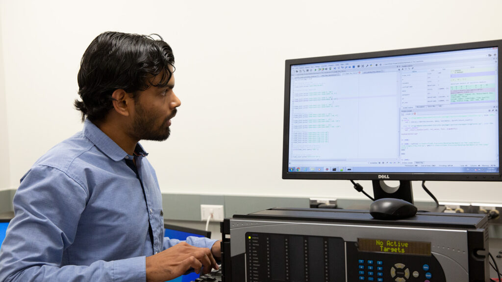 A man looks at a computer program running on a screen